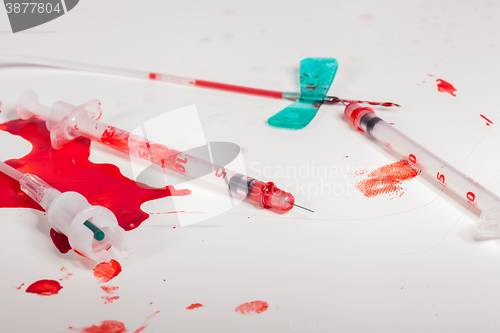 Image of Syringes and IV Lines Covered with Blood