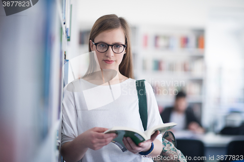 Image of portrait of famale student reading book in library