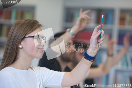 Image of group of students  raise hands up