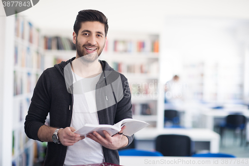 Image of portrait of student while reading book  in school library