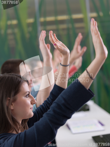 Image of students group raise hands up on class