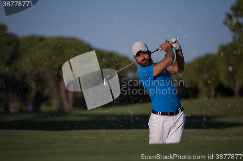 Image of pro golfer hitting a sand bunker shot