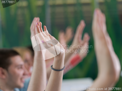 Image of students group raise hands up on class