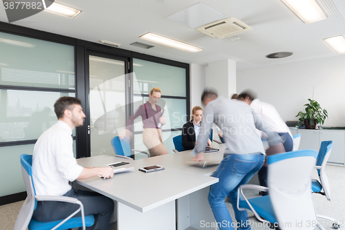 Image of business people group entering meeting room, motion blur