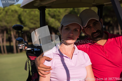 Image of couple in buggy on golf course