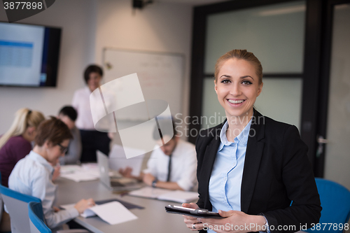Image of business woman working on tablet at meeting room