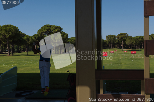 Image of golf player practicing shot on training