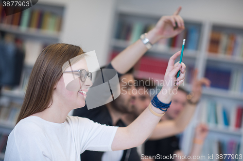 Image of group of students  raise hands up