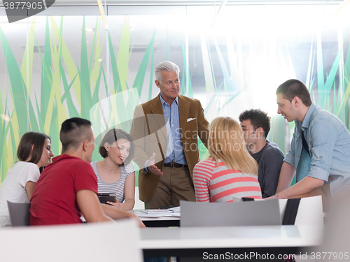 Image of teacher with a group of students in classroom