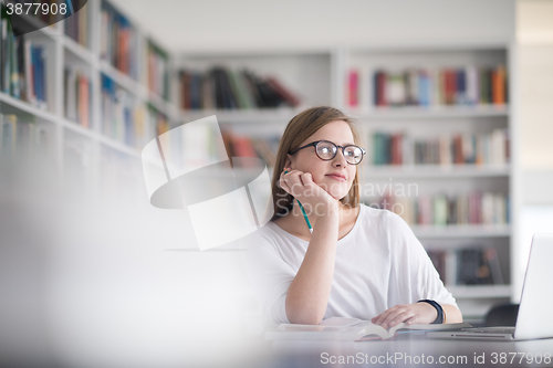 Image of female student study in school library