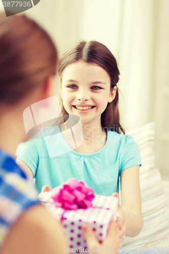 Image of happy little girls with birthday present at home