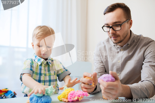 Image of father and son playing with ball clay at home