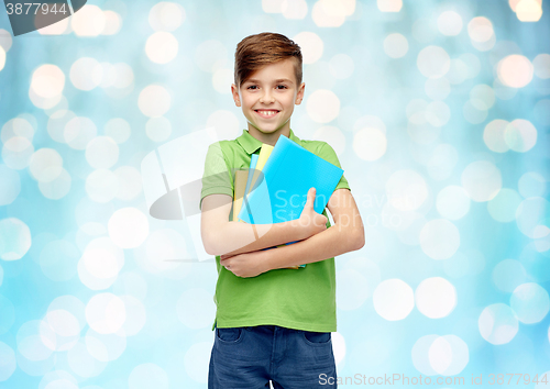 Image of happy student boy with folders and notebooks