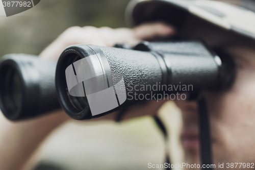 Image of close up of soldier or hunter with binocular