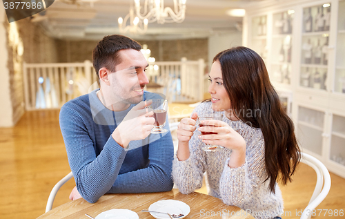 Image of happy couple drinking tea at cafe