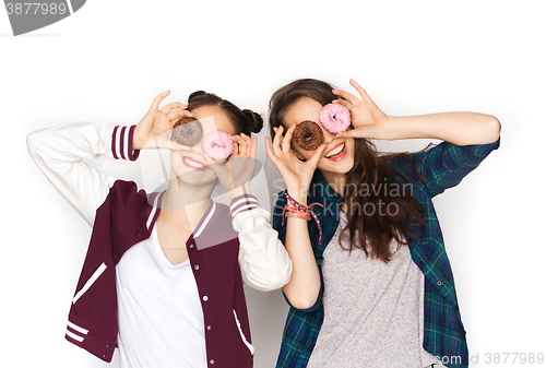 Image of happy pretty teenage girls with donuts having fun