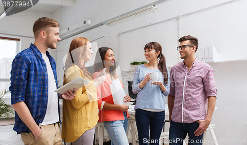 Image of creative team on coffee break talking at office