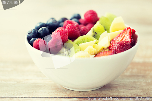 Image of close up of fruits and berries in bowl on table