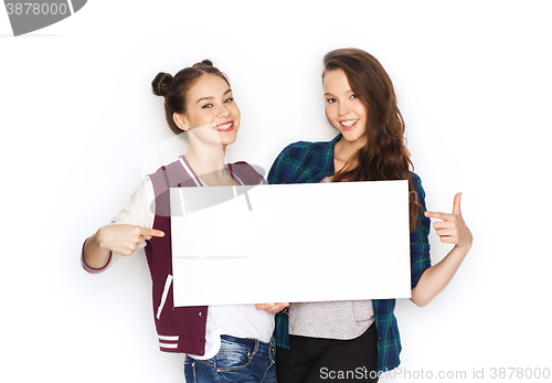 Image of smiling teenage girls holding white blank board