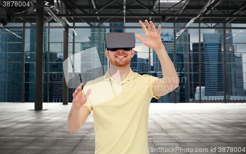 Image of happy man in virtual reality headset or 3d glasses