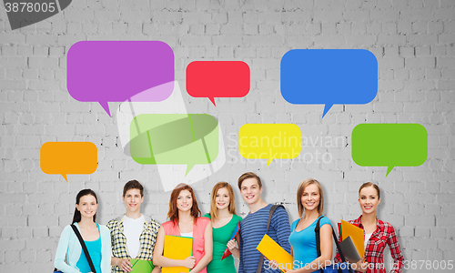 Image of group of teenage students with folders and bags