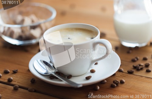 Image of close up coffee cup and grains on wooden table