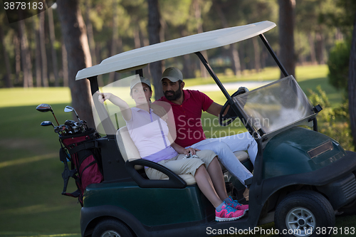 Image of couple in buggy on golf course