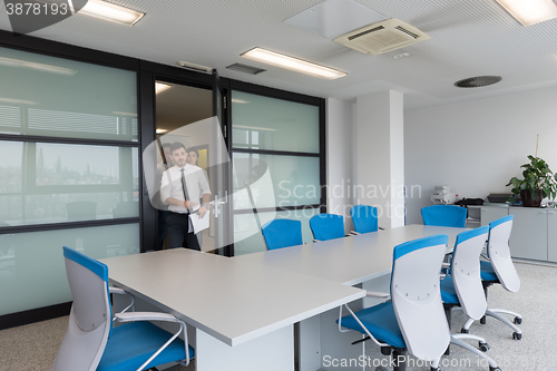 Image of business people group entering meeting room, motion blur