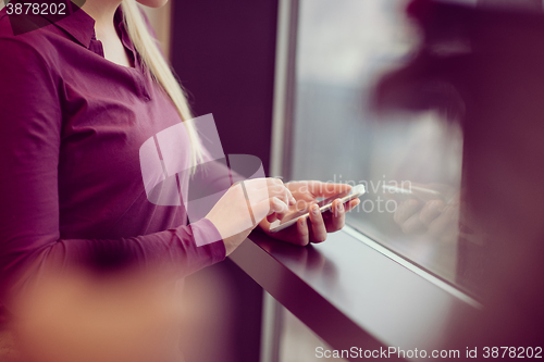 Image of business woman using smart phone at office