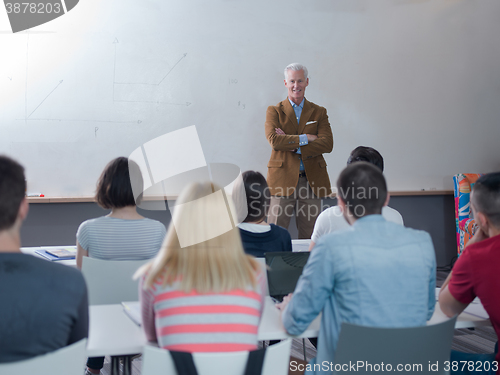 Image of teacher with a group of students in classroom