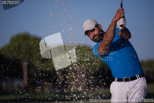 Image of pro golfer hitting a sand bunker shot