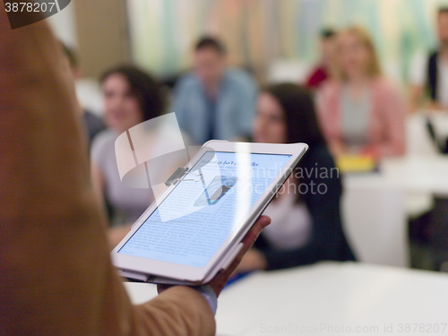 Image of Closeup  teacher hands and tablet while teaching studens in mode