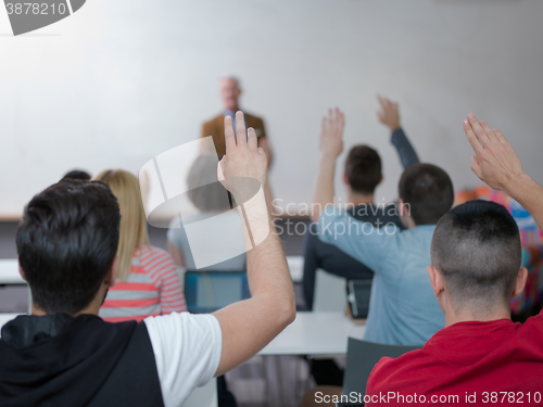 Image of students group raise hands up on class