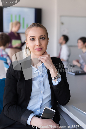 Image of portrait of young business woman at office with team on meeting 