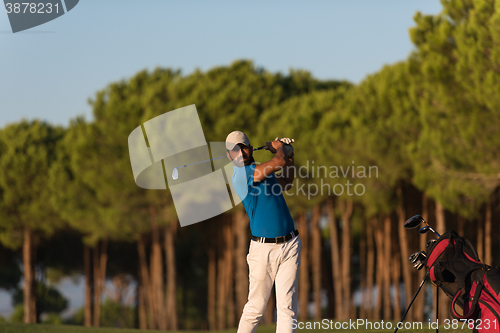 Image of golfer hitting a sand bunker shot on sunset