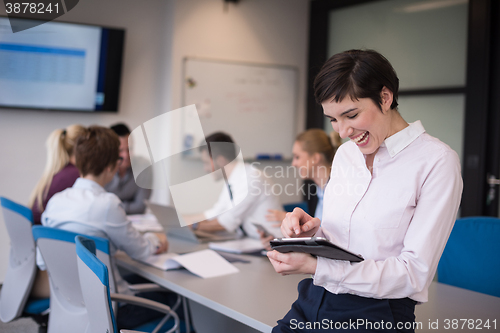 Image of business woman on meeting  using tablet