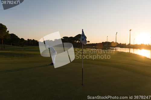 Image of golfer hitting ball to hole