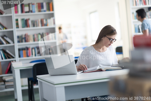 Image of female student study in school library