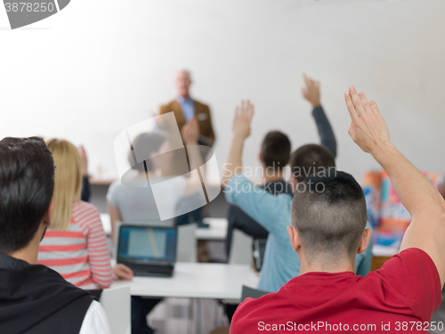 Image of students group raise hands up on class