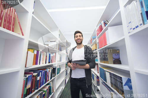 Image of student with tablet in library