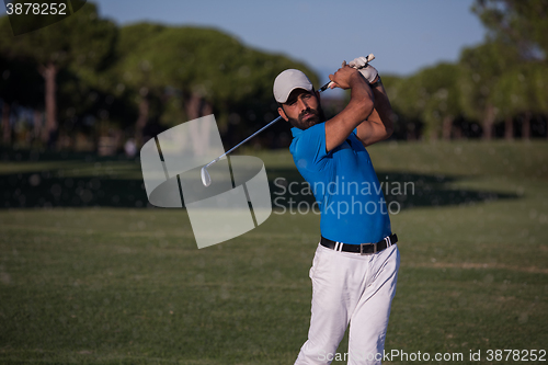 Image of pro golfer hitting a sand bunker shot