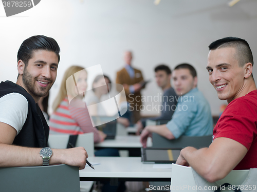 Image of teacher with a group of students in classroom