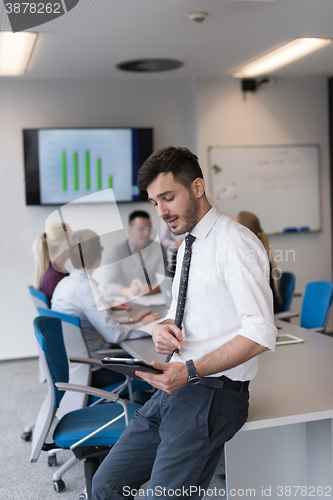 Image of young business man with tablet at office meeting room