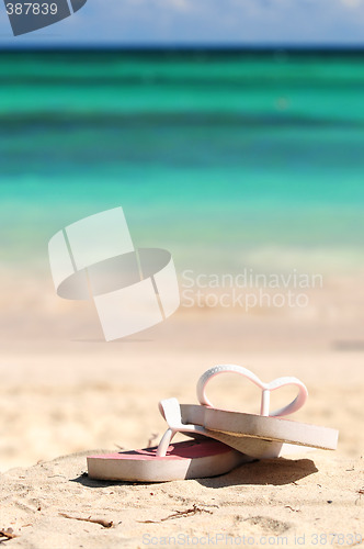 Image of Flipflops on a sandy beach