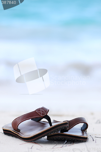 Image of Flipflops on a sandy beach