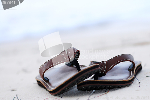 Image of Flipflops on a sandy beach