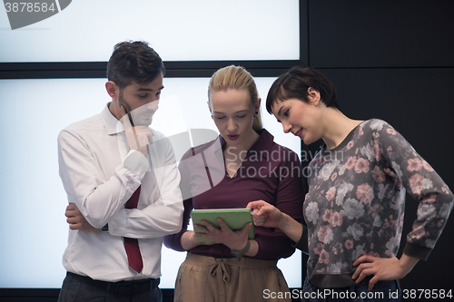 Image of young business people group working on tablet