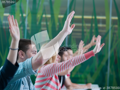 Image of students group raise hands up on class