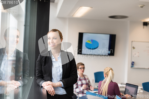 Image of portrait of young business woman at office with team on meeting 