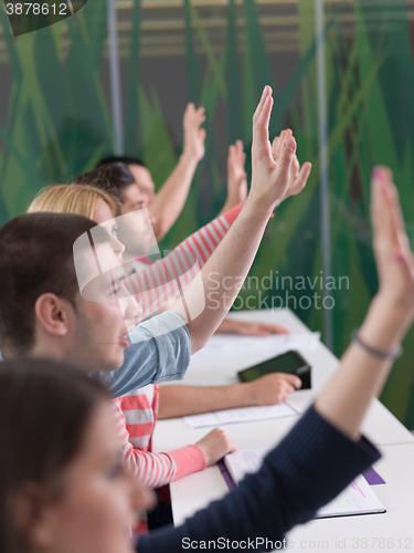 Image of students group raise hands up on class